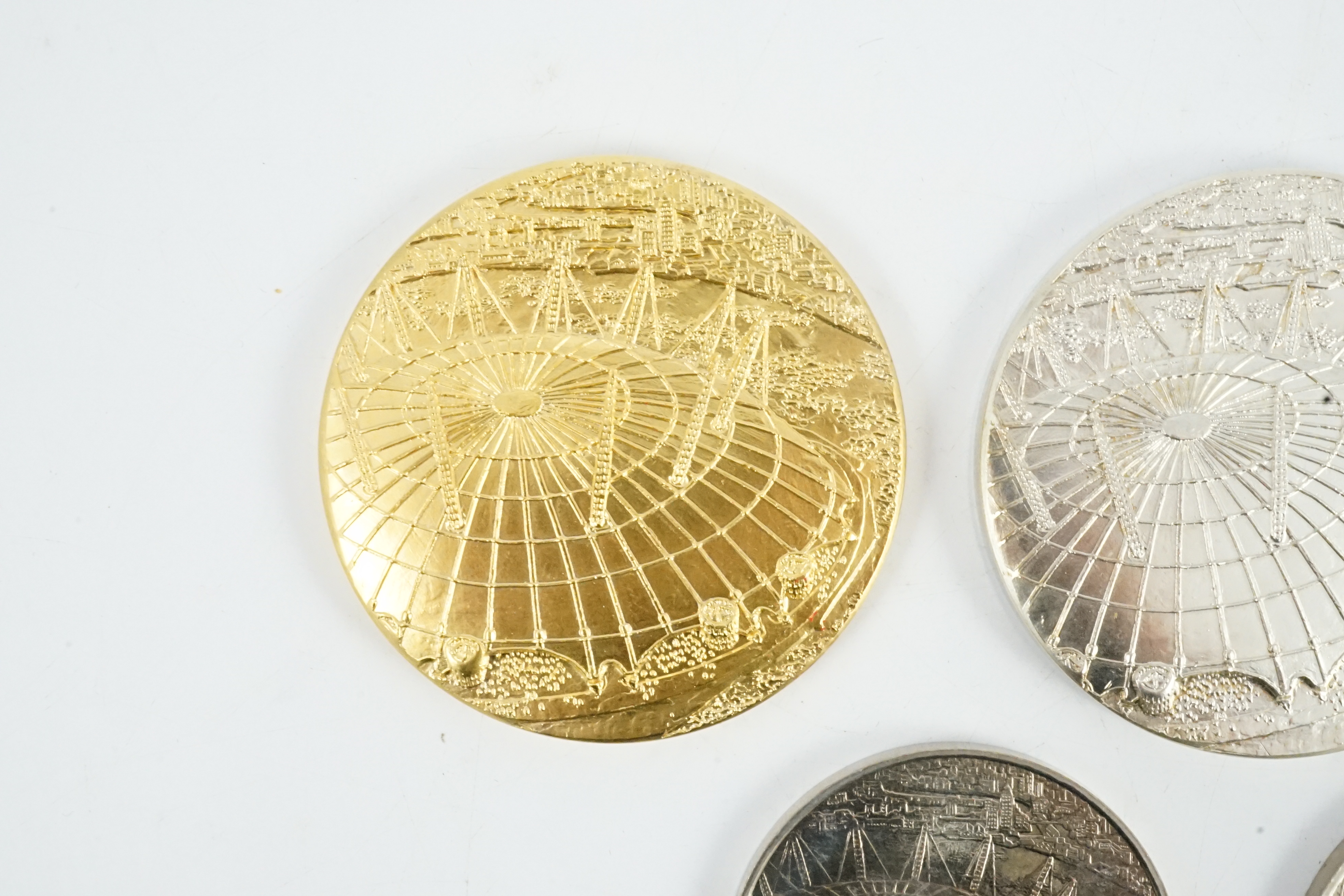 Jacqueline Stieger (b.1936) for Royal Mint, two prototype silver-gilt (Millennium) Dome medals, and a similar first strike silver medal